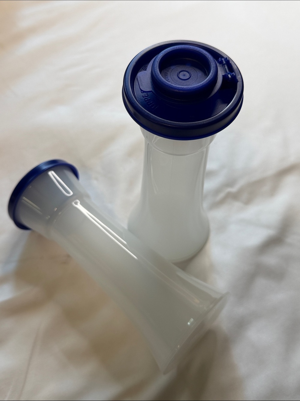 Tupperware large, hourglass salt and pepper shakers with blue lids